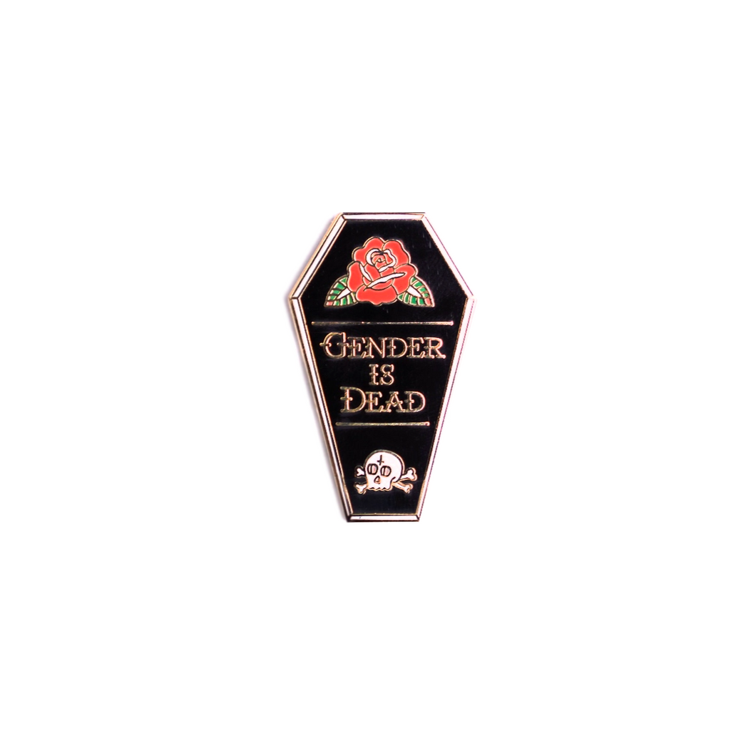 Enamel pin of a black coffin with a red rose with leaves on the top and a white skull and crossbones on the bottom, in the middle is text that reads 