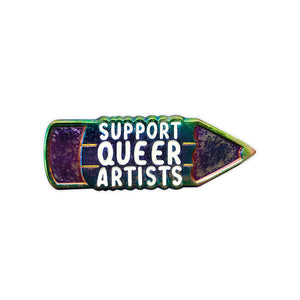 Enamel pin of a holographic pencil with text that reads "support queer artists" in white lettering in the middle of the pencil. 