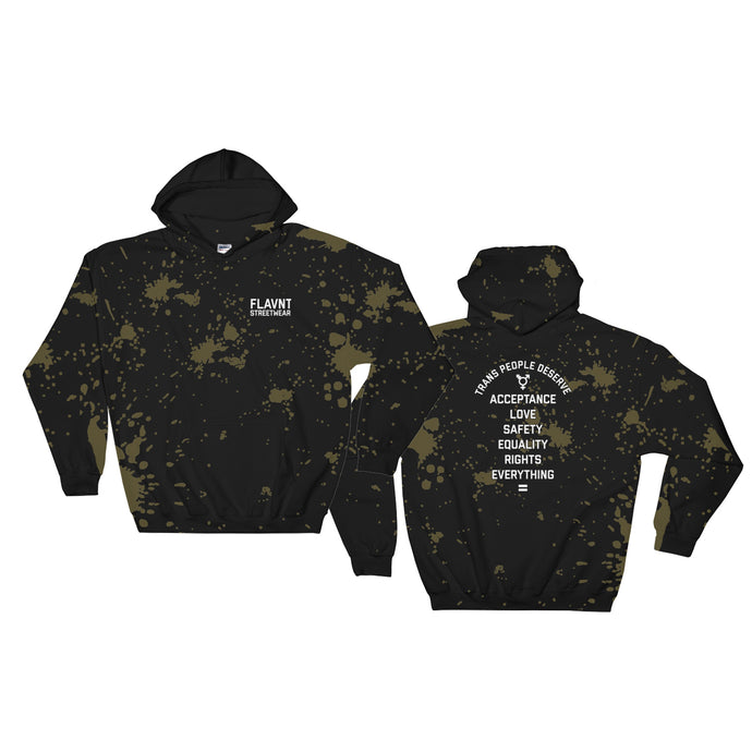 A black sweatshirt with bleach splatters on it, on the front in the left corner is text that reads 