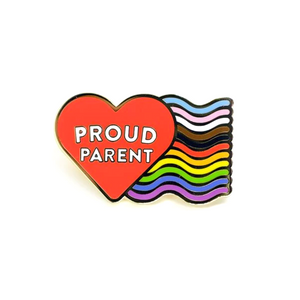 Enamel pin of a red heart that reads "Proud Parent" in white text with an inclusive rainbow containing both the trans pride colors and a black and brown stripe coming off the right side.  